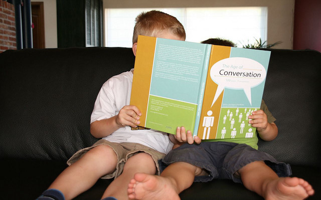 two kids reading a book together