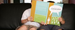 two kids reading a book together