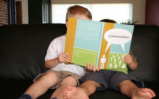 two kids reading a book together
